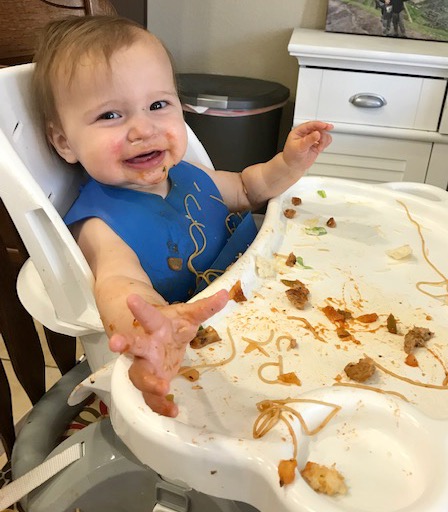 Baby loving baby-led weaning mealtime