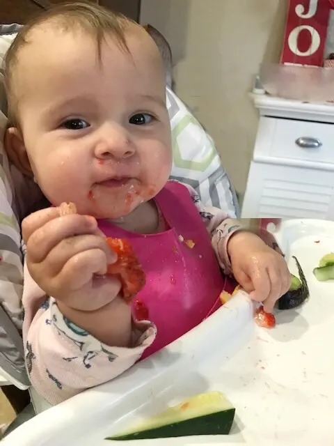 baby eating food through baby led weaning