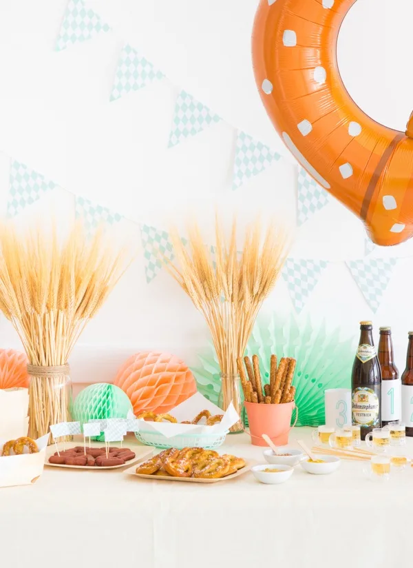 Oktoberfest baby shower idea- table set with wheat, pretzels, and beer