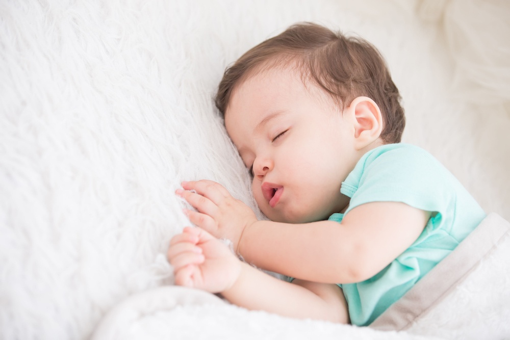 baby sleeping with a blanket