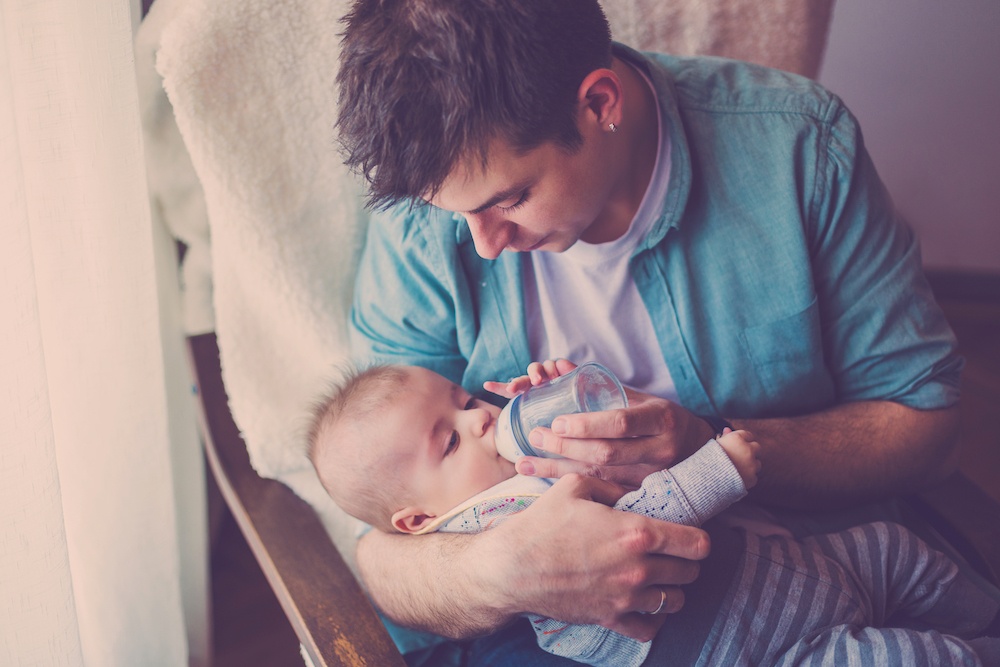 dad dream feeding baby with bottle