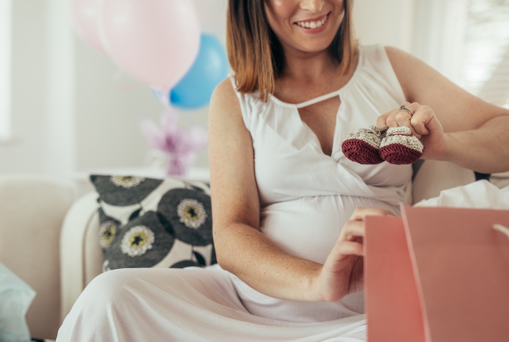 mom opening up gifts at baby shower