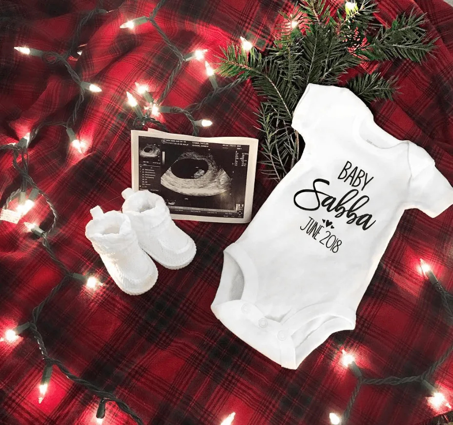 Christmas pregnancy announcement with onesie and sonogram