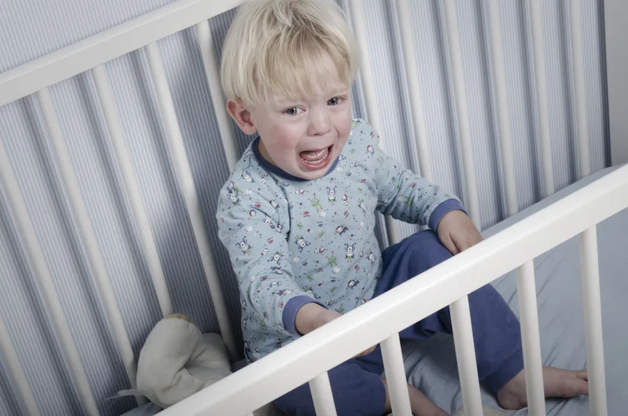 2 year old crying in his crib during common two year sleep regression