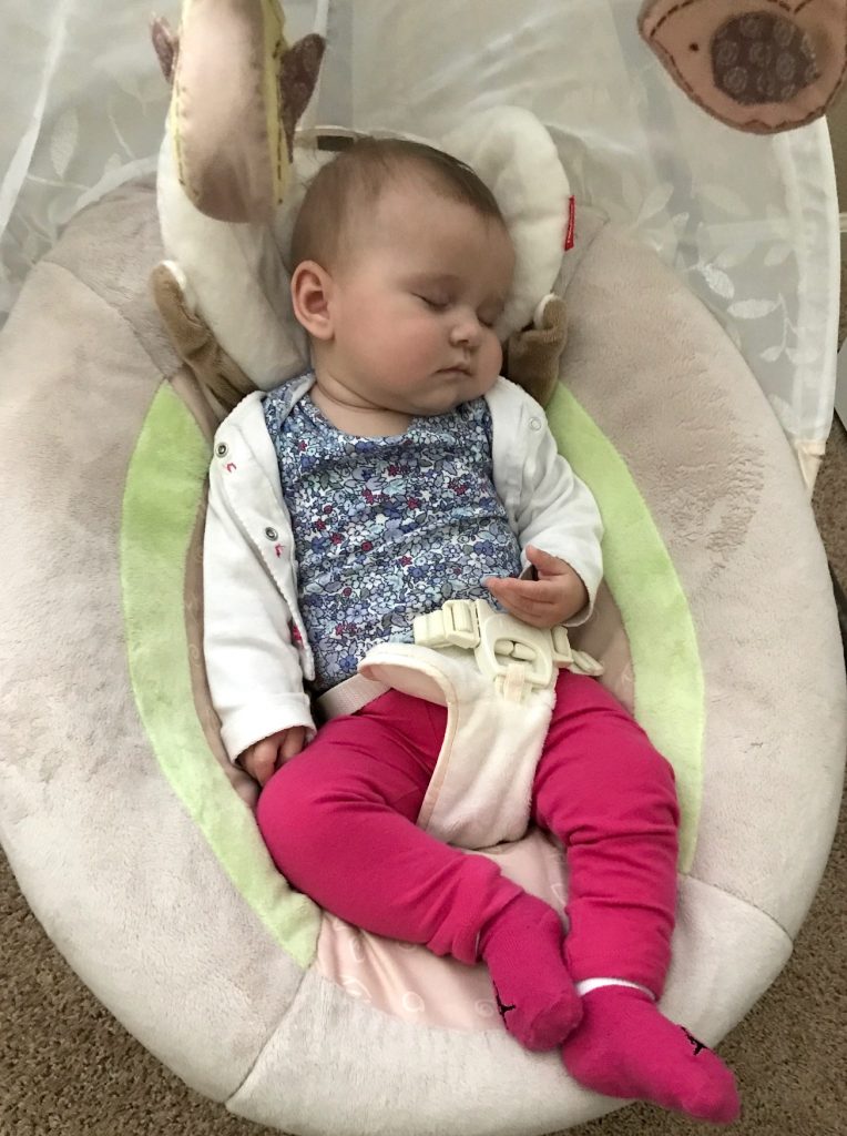baby sleeping in a baby swing