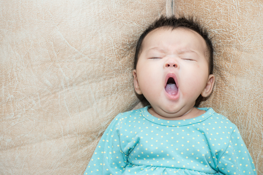 baby yawning showing sleep cues