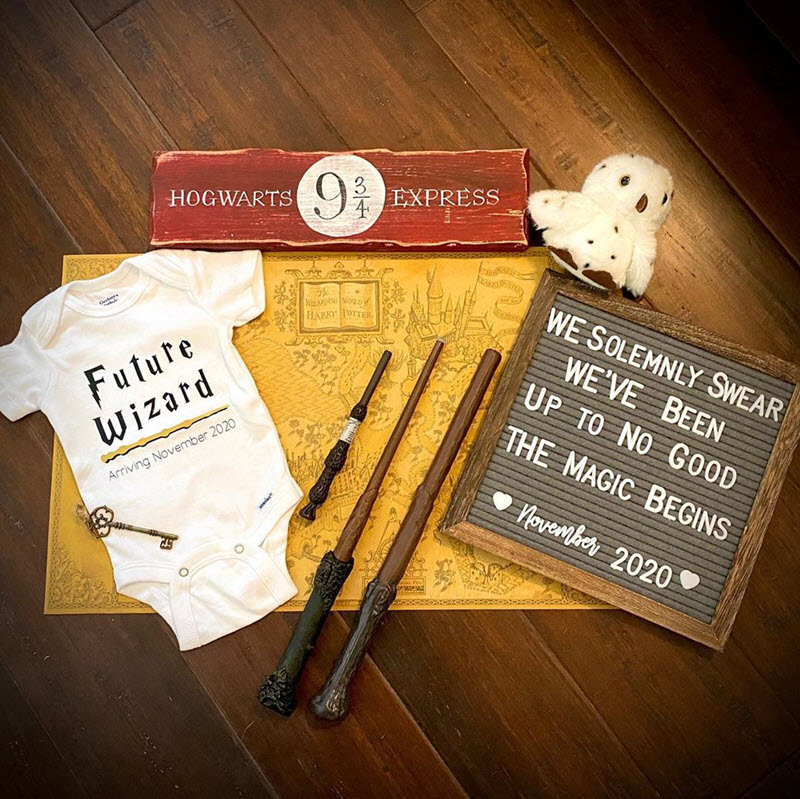 Harry Potter pregnancy announcement on letterboard with onesie and wands