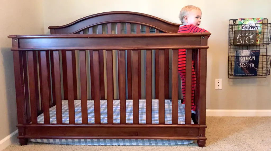 toddler trying to climb out of crib