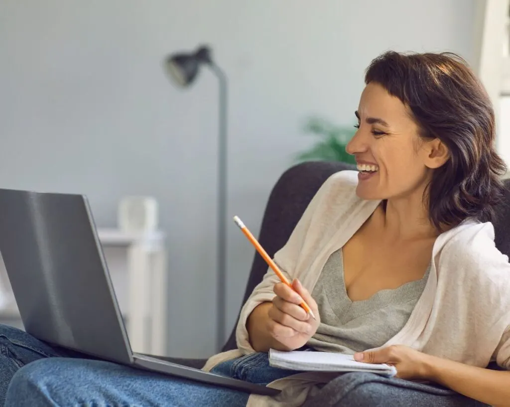 woman laughing with laptop