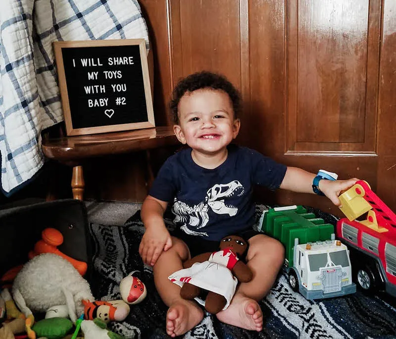 little boy playing with toys and announcing mom's pregnancy