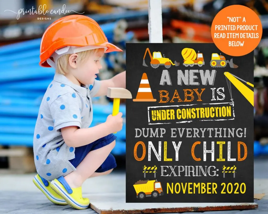 little boy holding only child expiring construction sign