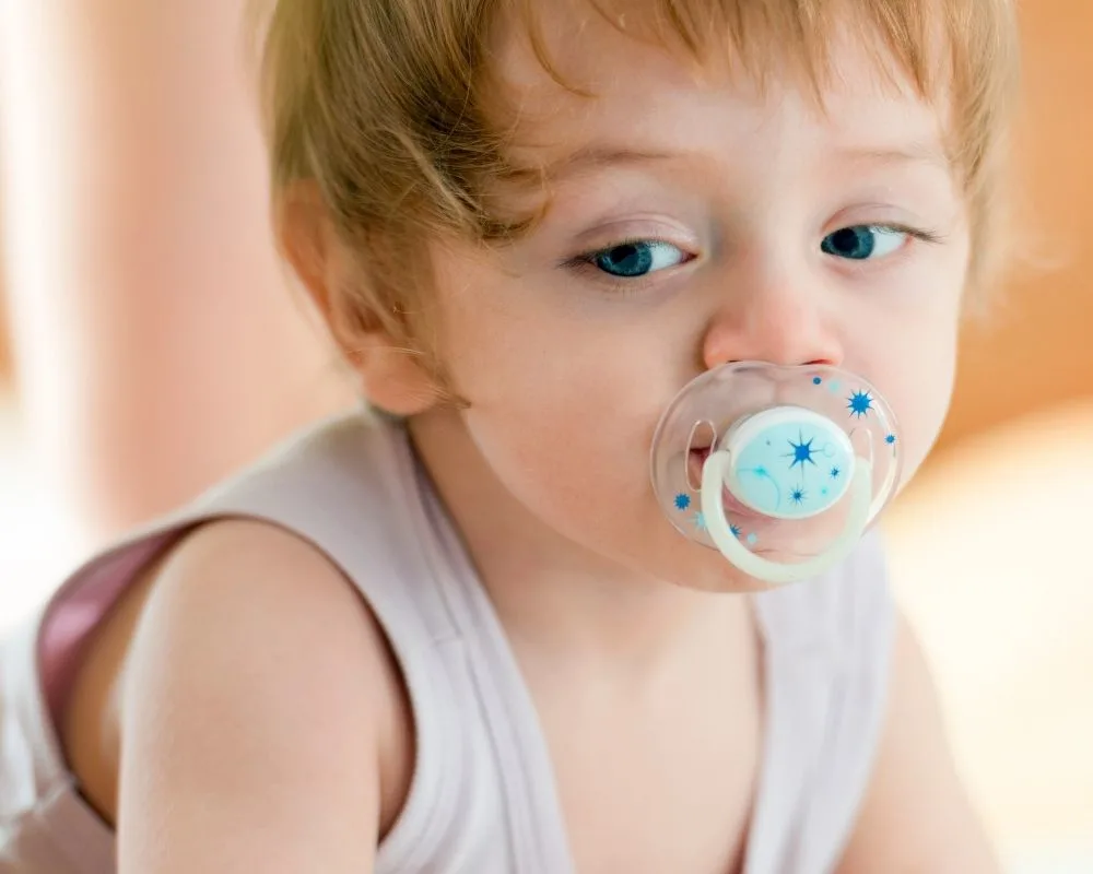 toddler with pacifier in mouth