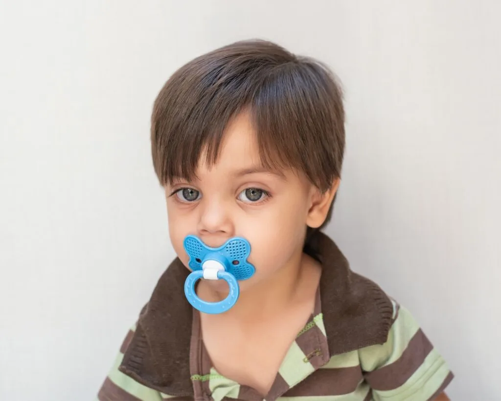 older toddler using a pacifier