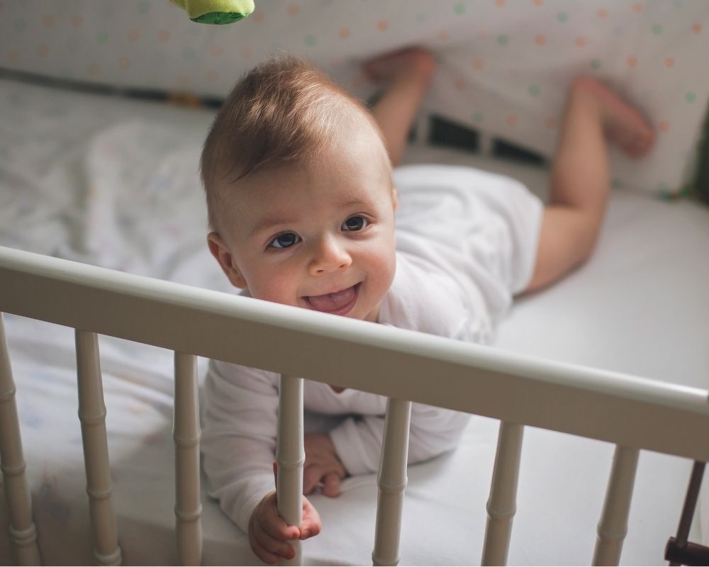 baby in lowered crib