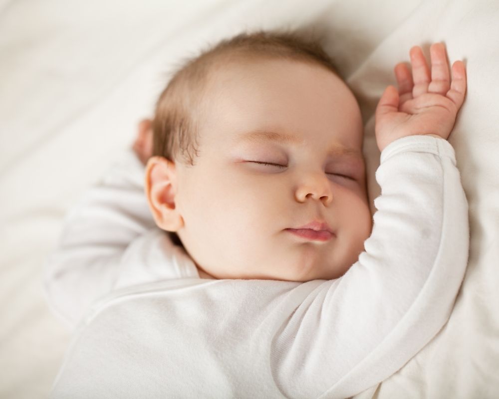 baby sleeping with arms up
