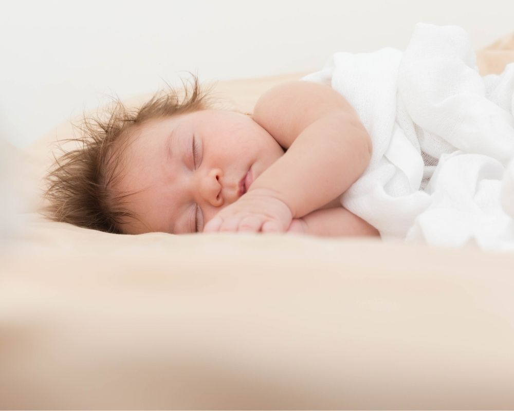 baby sleeping on a newborn lounger