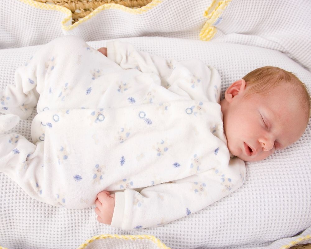 baby sleeping on pillow-like surface