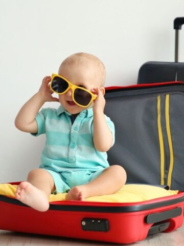 baby on suitcase for travel