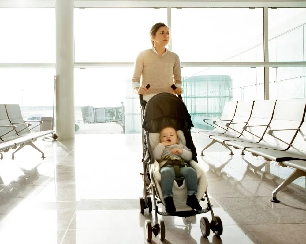 mom pushing baby in a stroller at airport