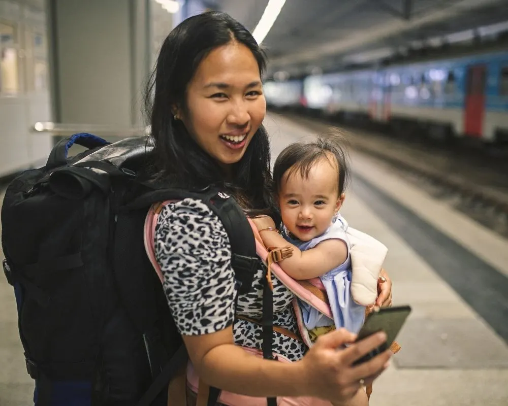 mom traveling with baby in a subway station