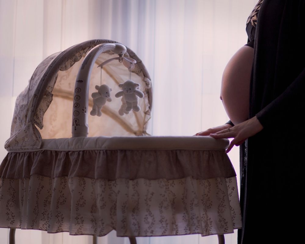 pregnant mom near bassinet
