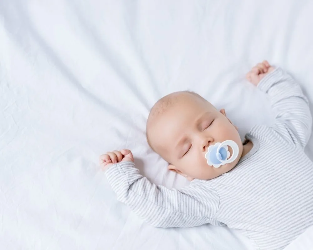 baby sleeping with pacifier in mouth