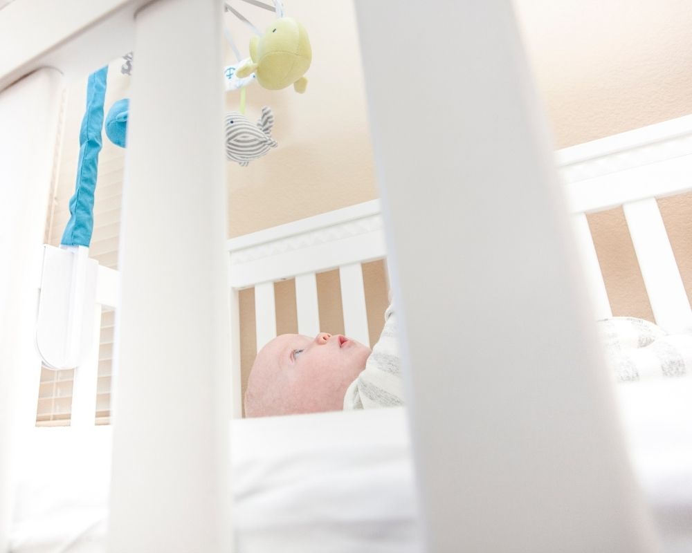 Baby rolls over in their crib and wakes up