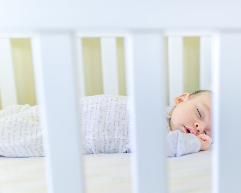 Baby napping in crib