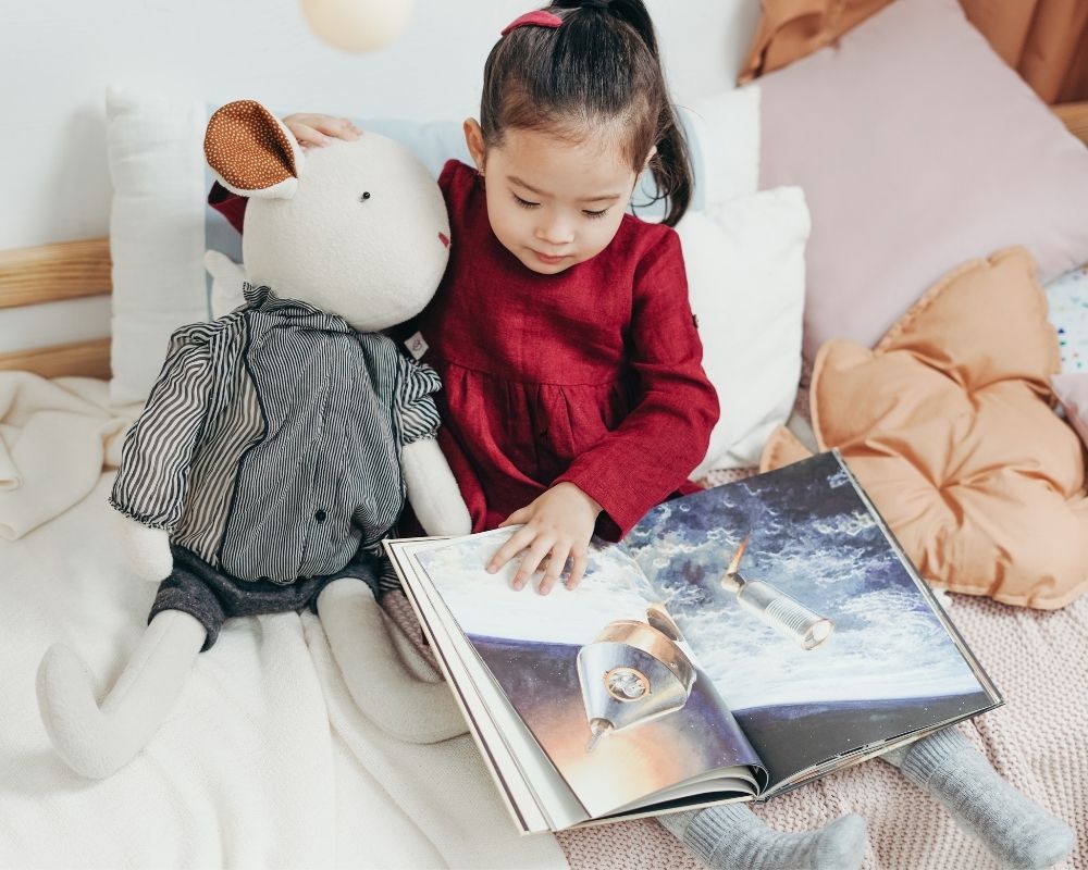 Three year old reading during quiet time schedule