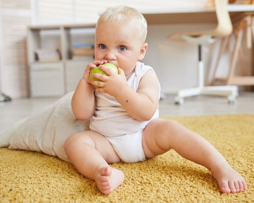 baby eating a pear