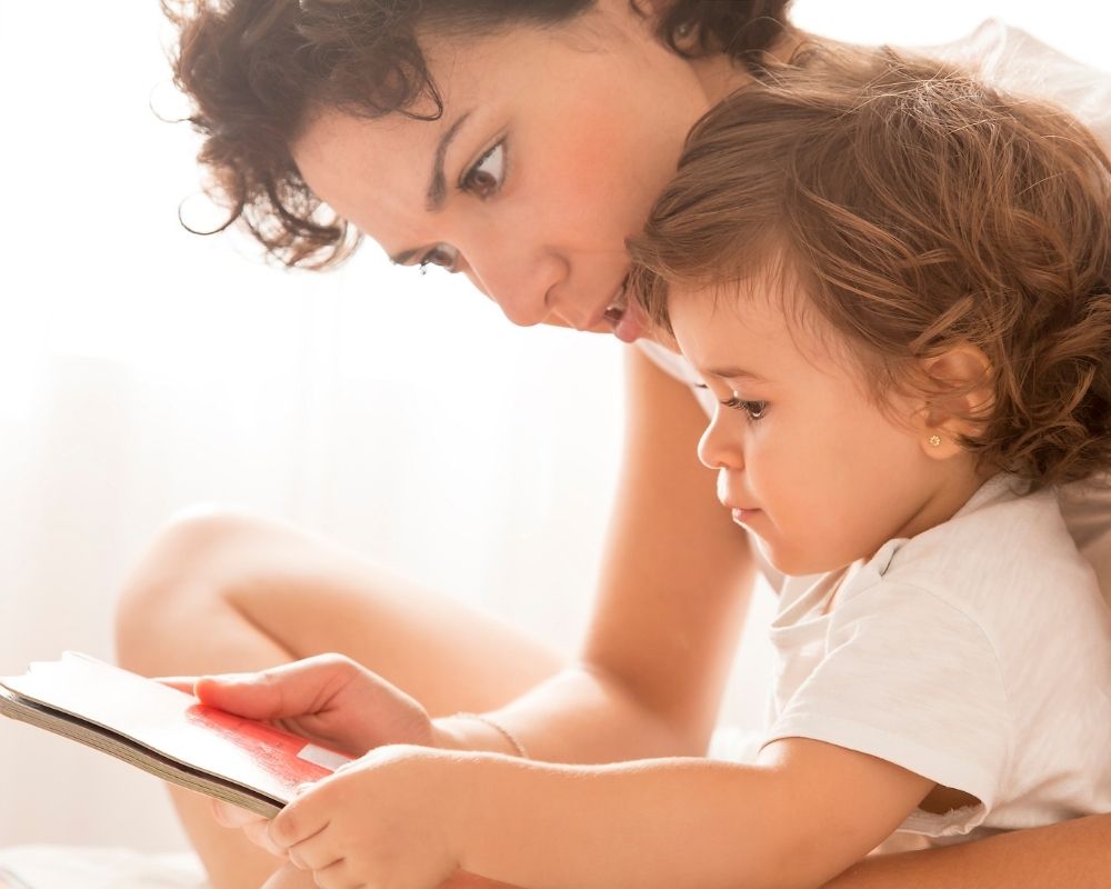 Mom reading to toddler for nap