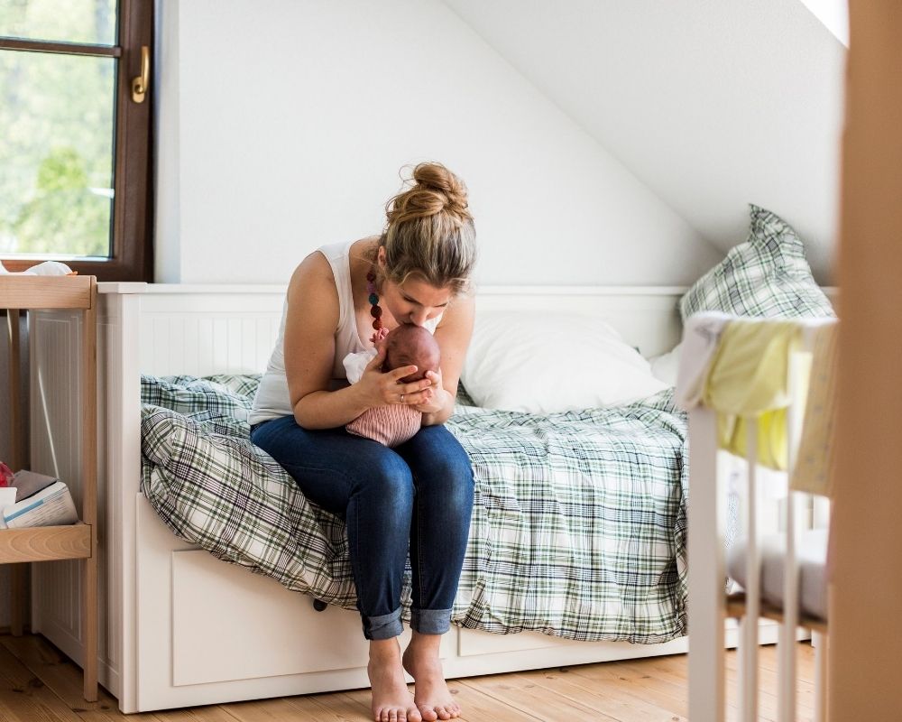 mom cuddling baby before nap time