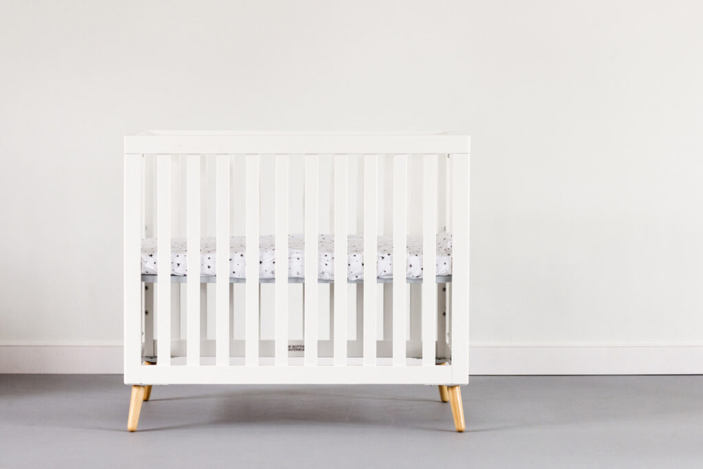 How low should outlet crib mattress be