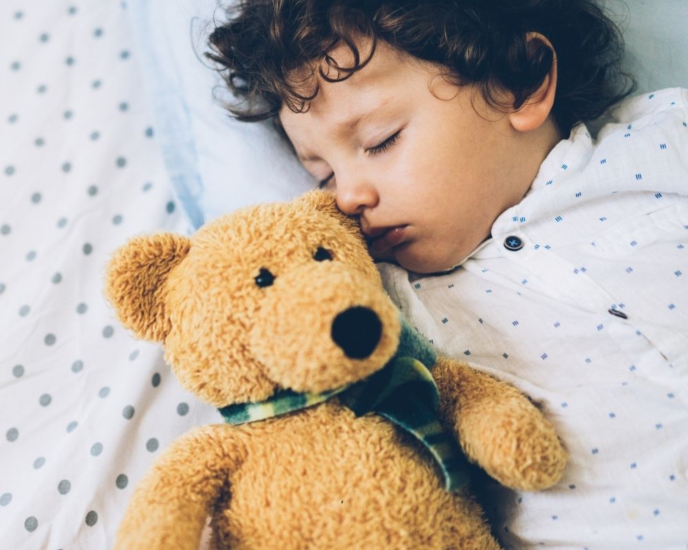 12 month old baby sleeping with a teddy bear