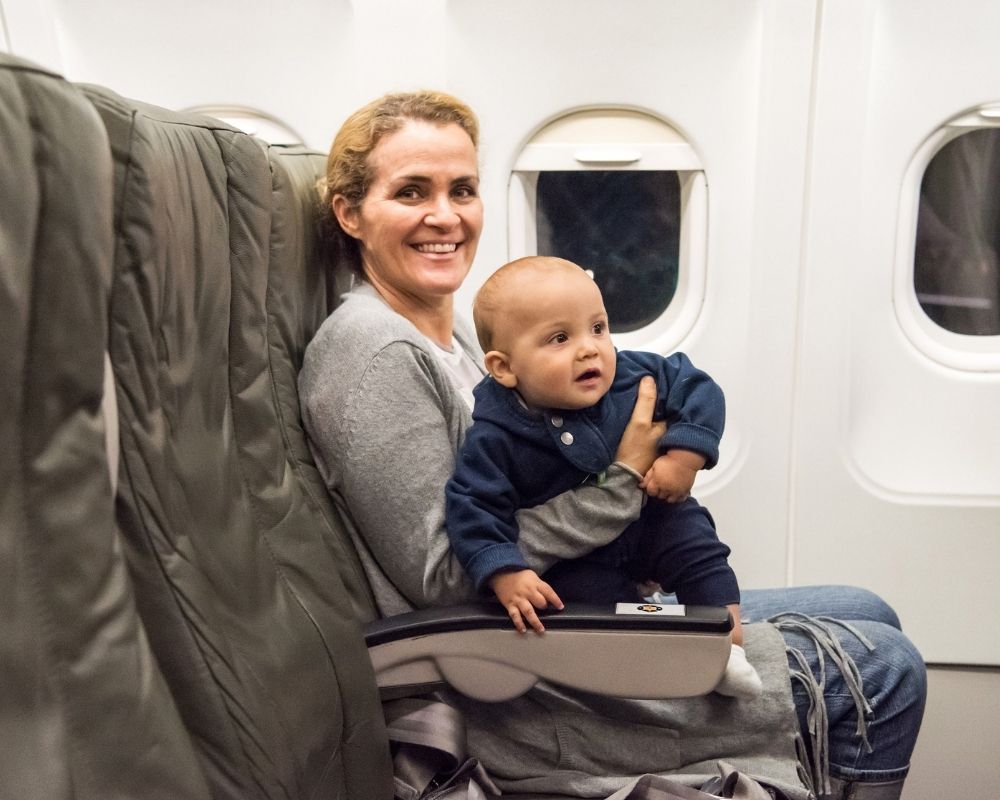 mom on airplane with baby