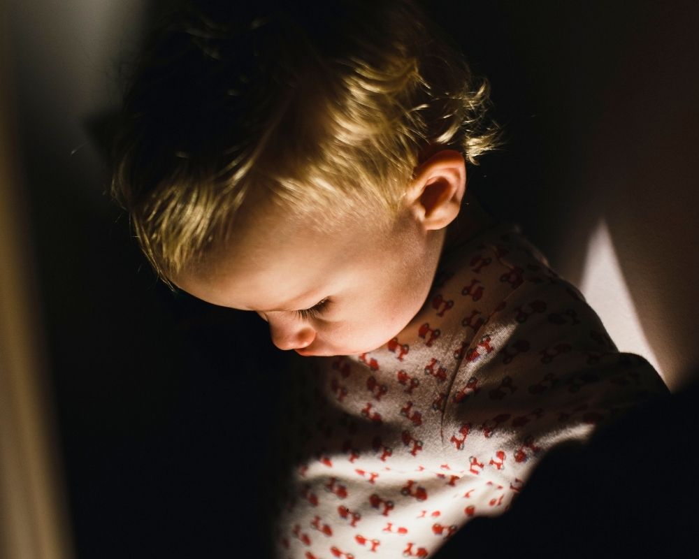 baby in dark nursery