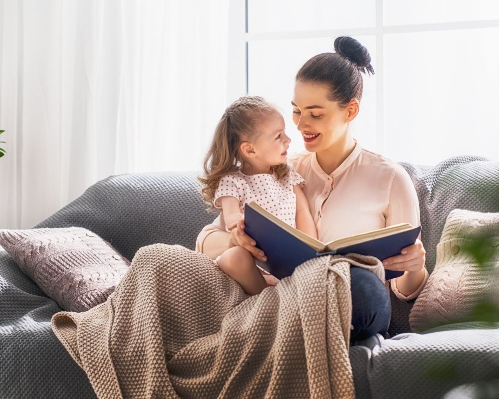 mom reading books with daughter before quiet time