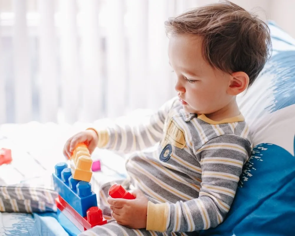toddler playing blocks quietly in bed instead of napping