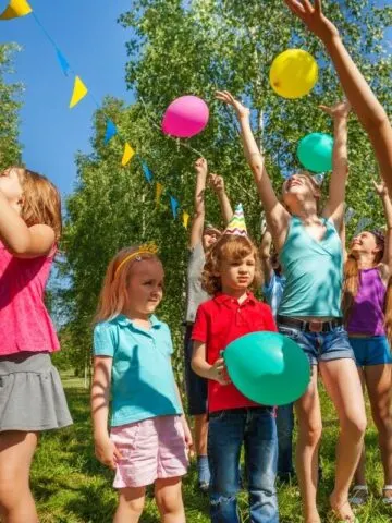 kids at baby shower playing with balloons
