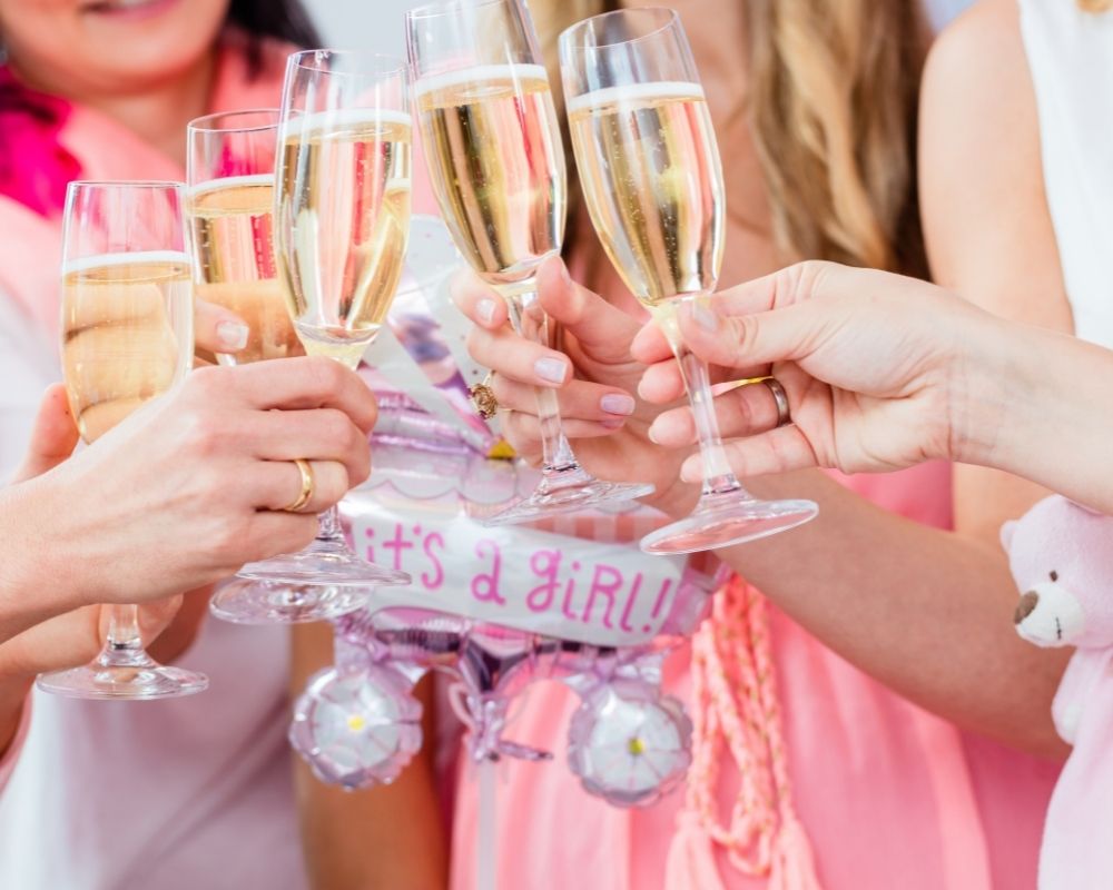 woman cheersing champagne at baby shower