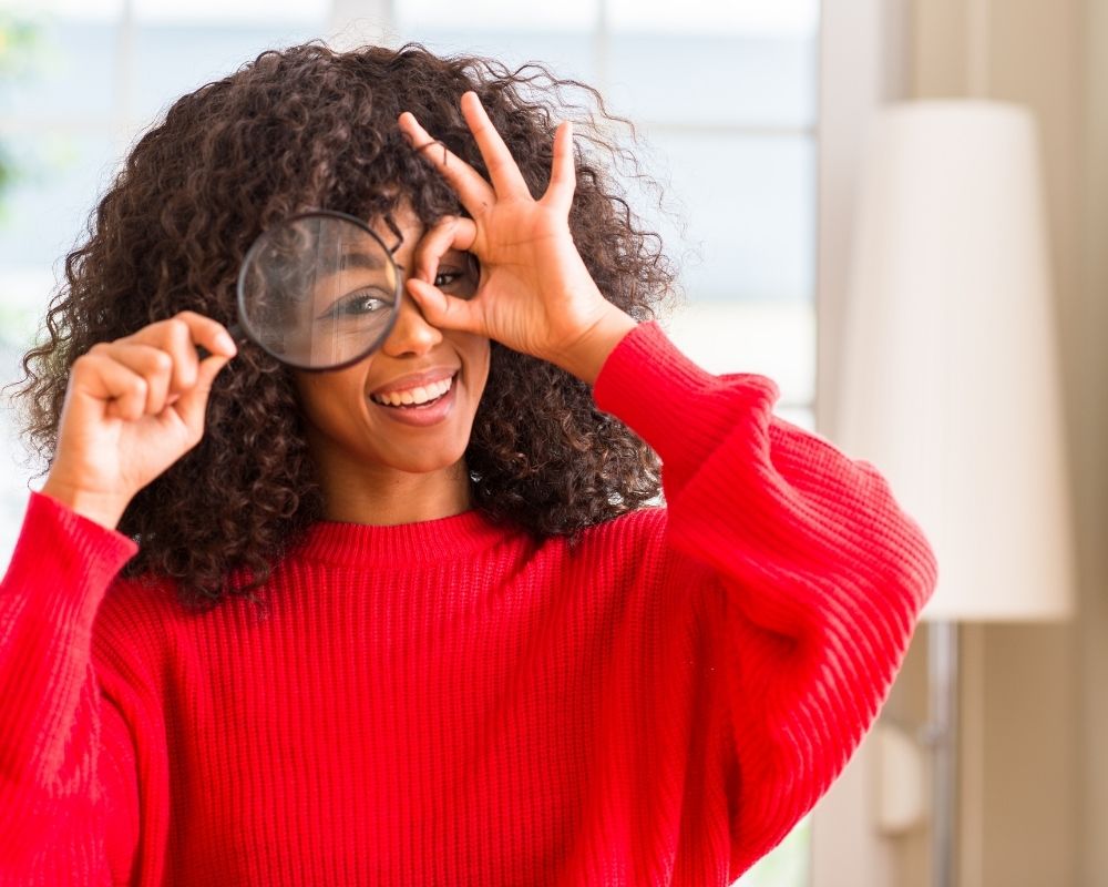 lady looking through magnifying glass