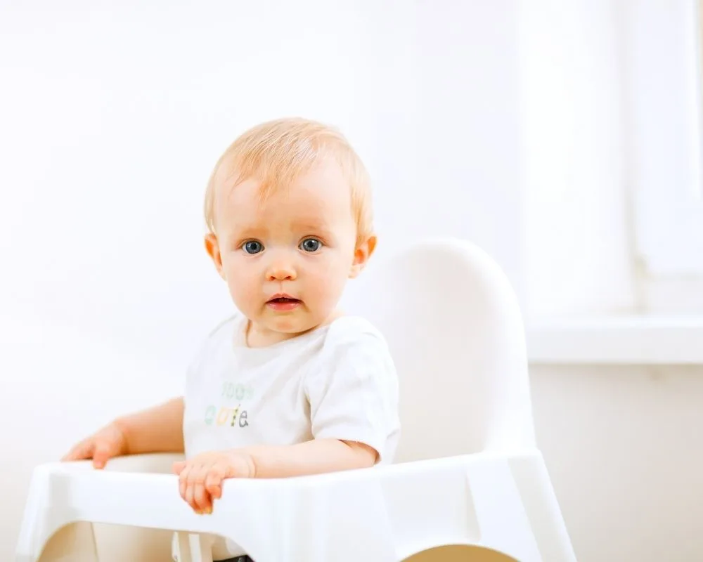 baby in a simple baby led weaning high chair