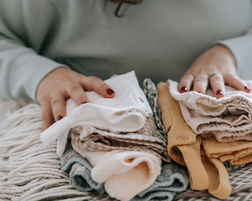 mom organizing baby clothes