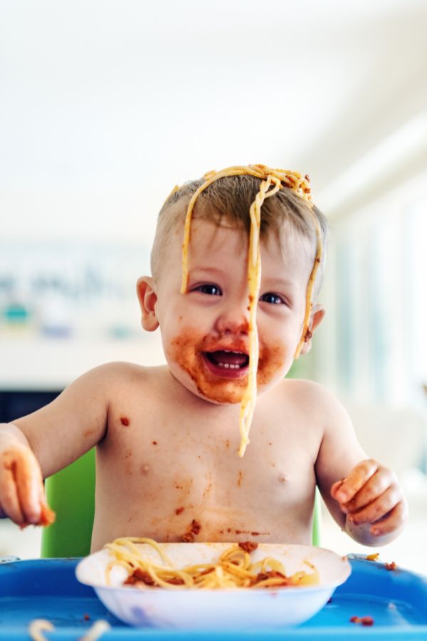 baby eating spaghetti with baby led weaning