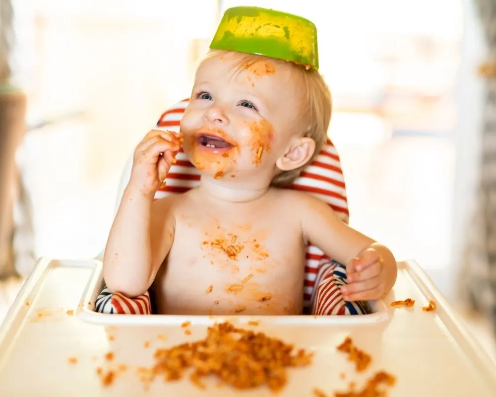 baby led weaning vs purees: baby eating spaghetti in high chair
