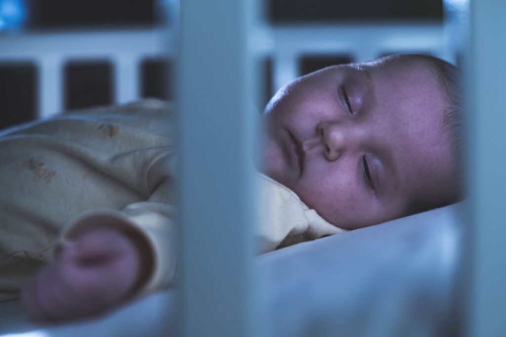 baby sleeping at night in his crib