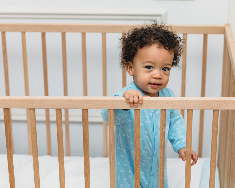Toddler standing in crib