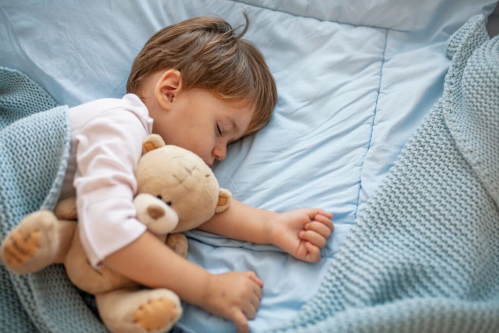 toddler boy sleeping with teddy bear