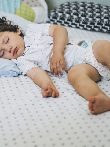 image of toddler sleeping in crib