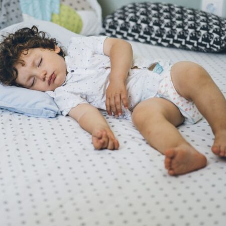 image of toddler sleeping in crib